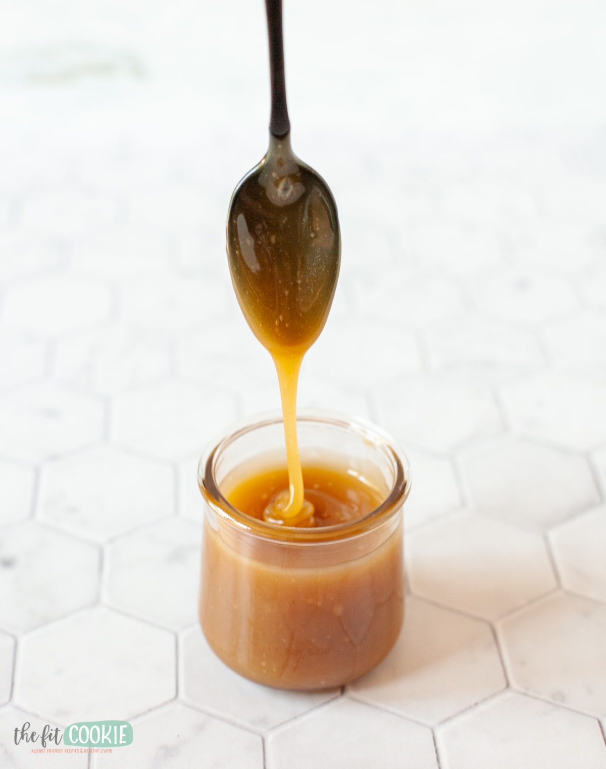 spoon drizzling easy caramel sauce into a small cup