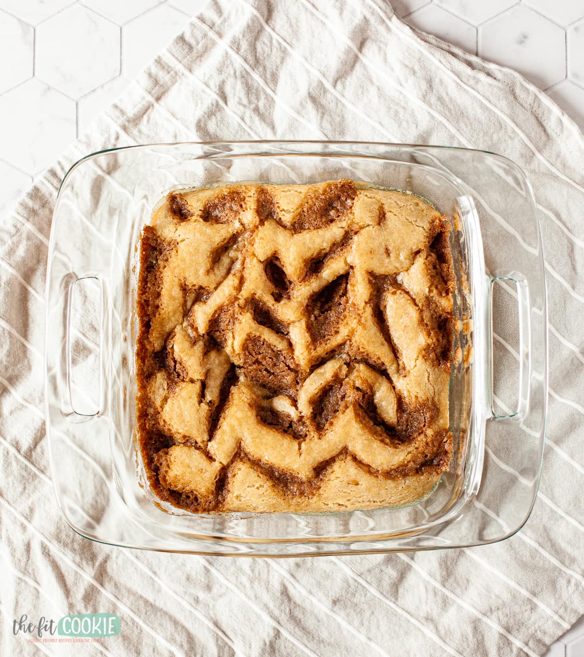 Glass pan with dairy free cinnamon roll cake in it