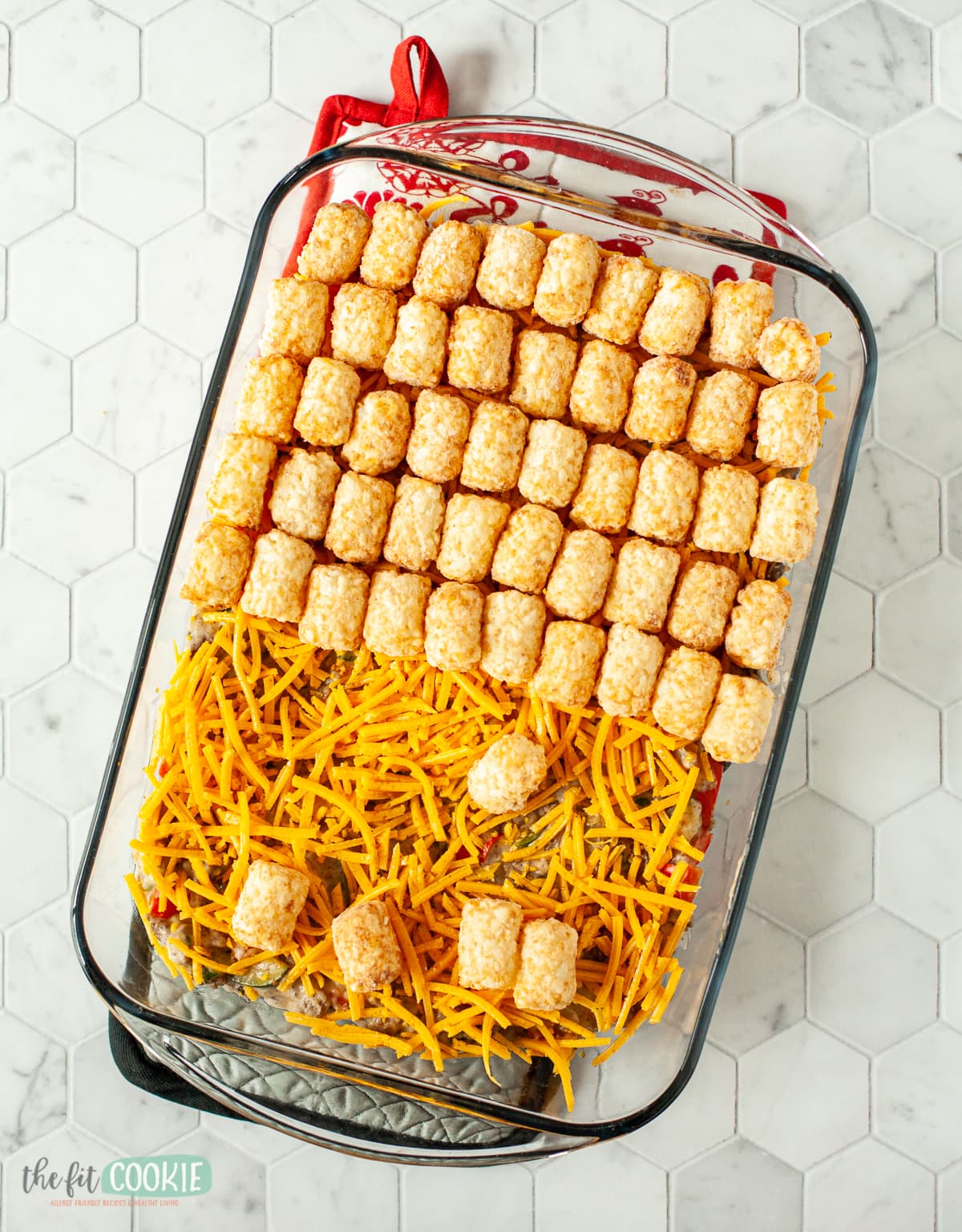 assembling a casserole in a glass pan