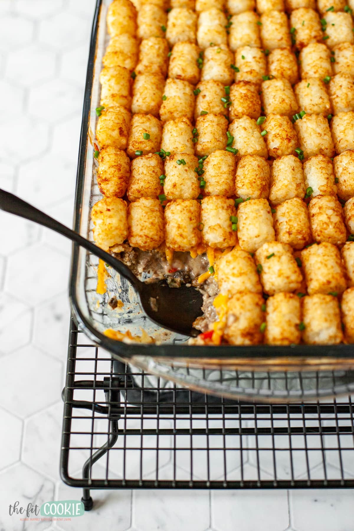 Glass pan of casserole on a cooling rack