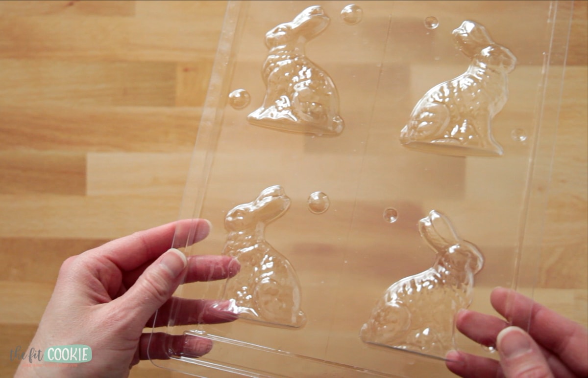 photo of hands holding a small chocolate bunny mold