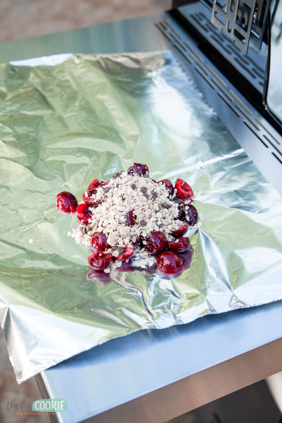 cherries and crumb topping on a piece of foil