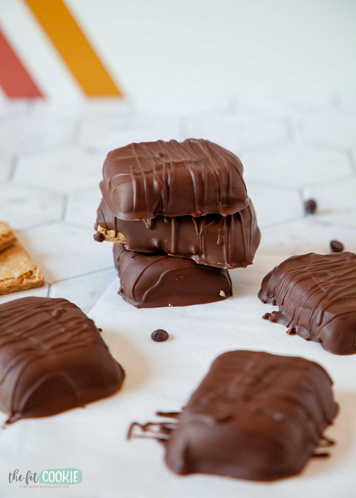 chocolate covered sunbutter graham crackers stacked on parchment paper