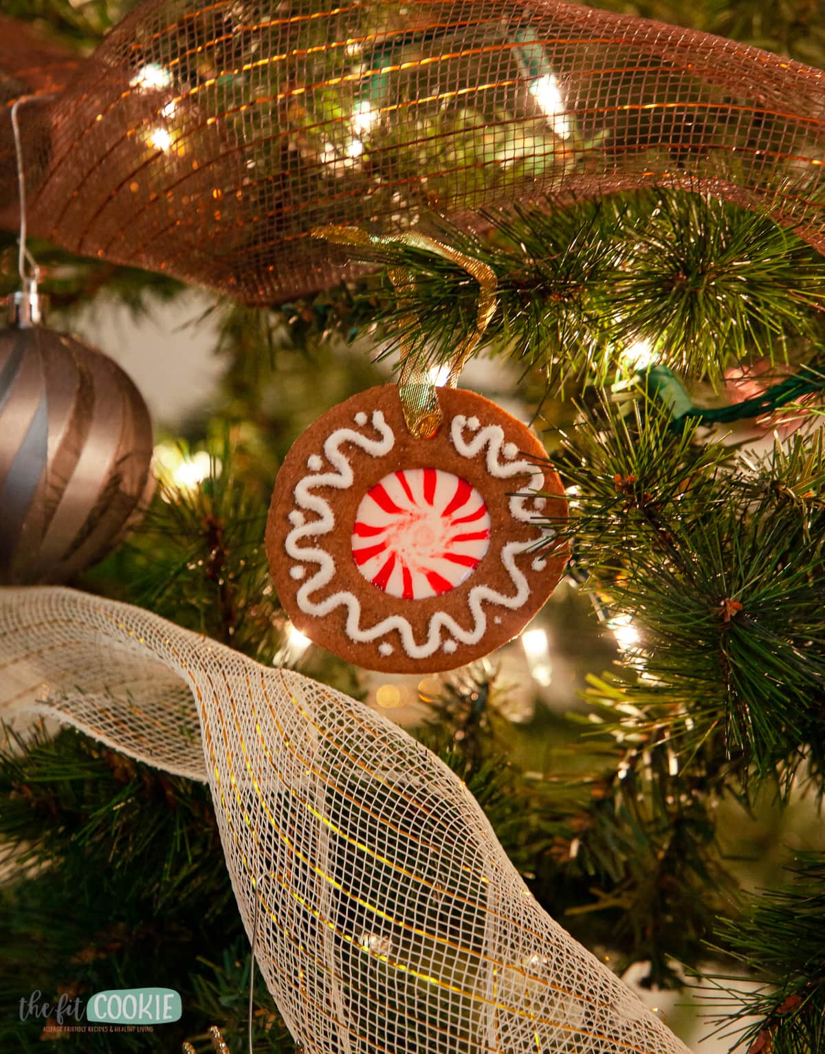 gingerbread cookie ornament hanging in a christmas tree
