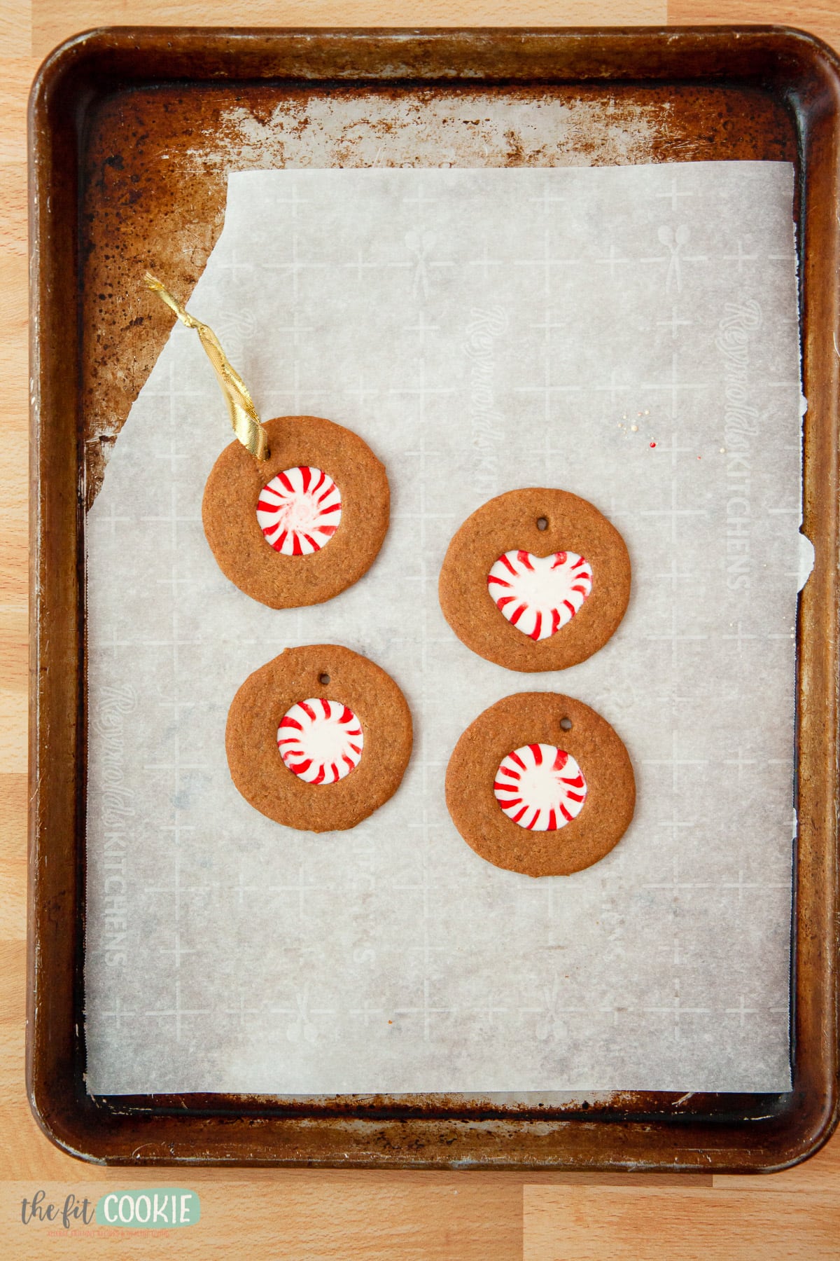 overhead photo showing cookie ornaments on a pan with parchment paper