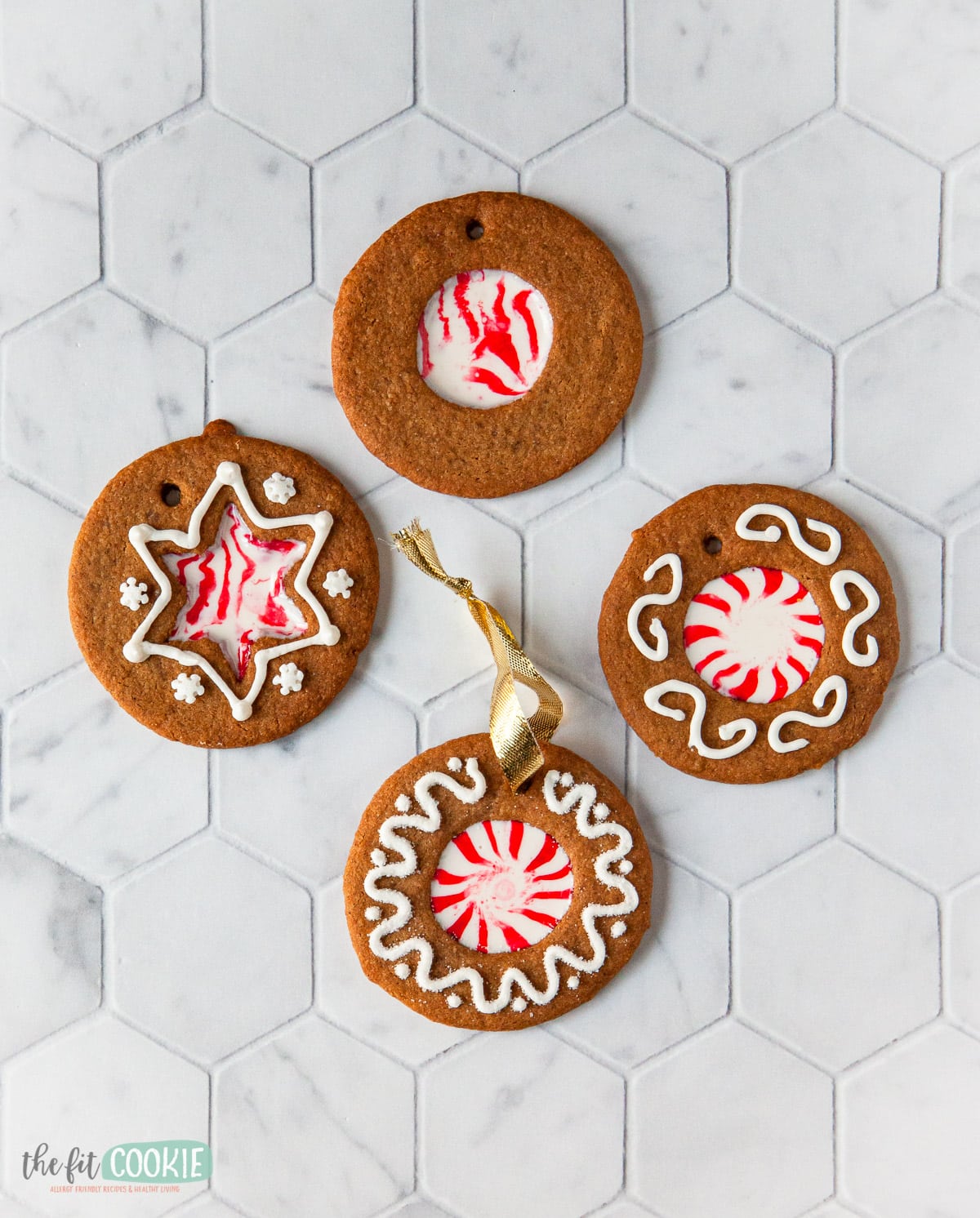 overhead photo of decorated gingerbread ornaments on a tile surface