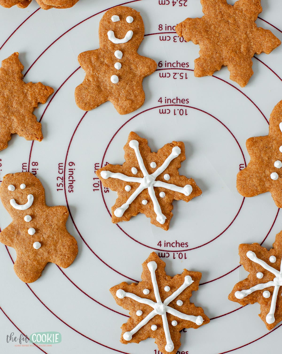 overhead photo of gingerbread cookies with white frosting on them
