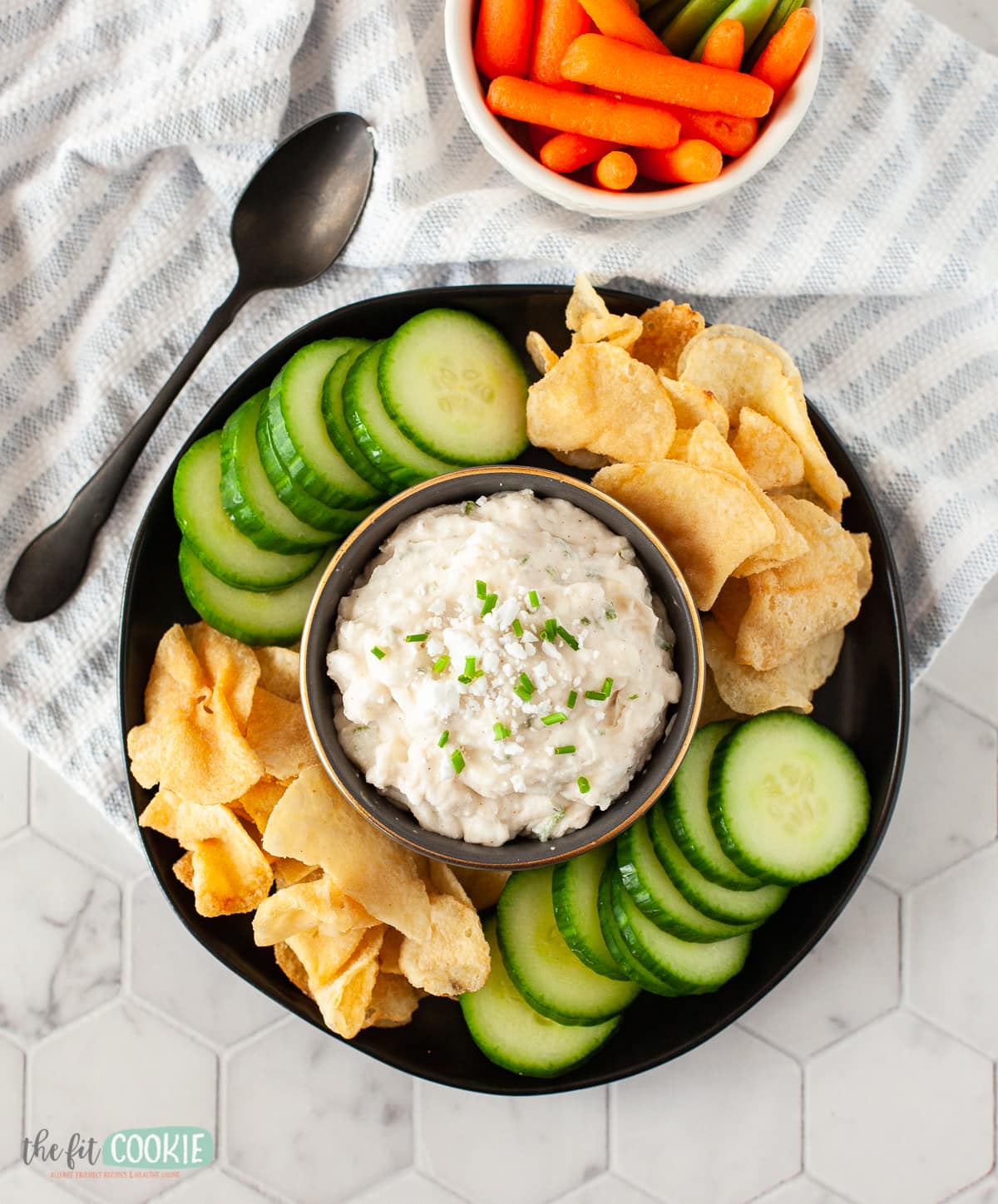 overhead photo of black plate with chips and dairy free feta dip