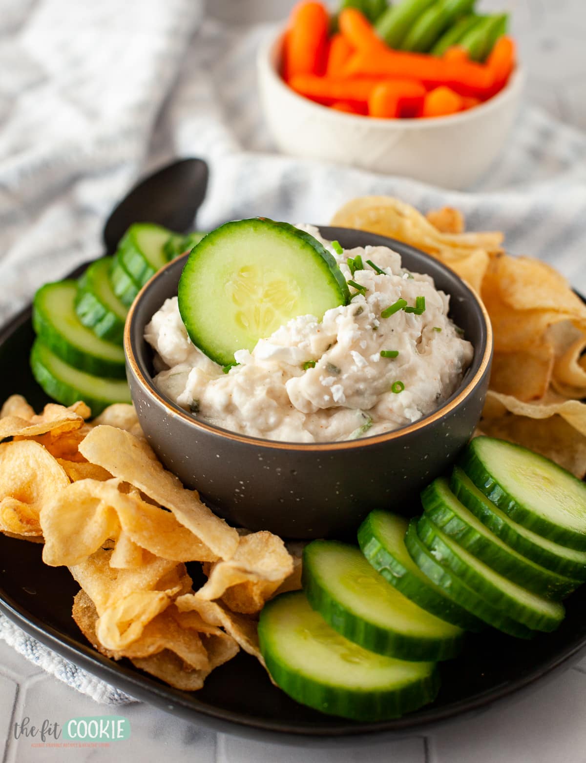 close up photo of feta dip with a slice of cucumber in it