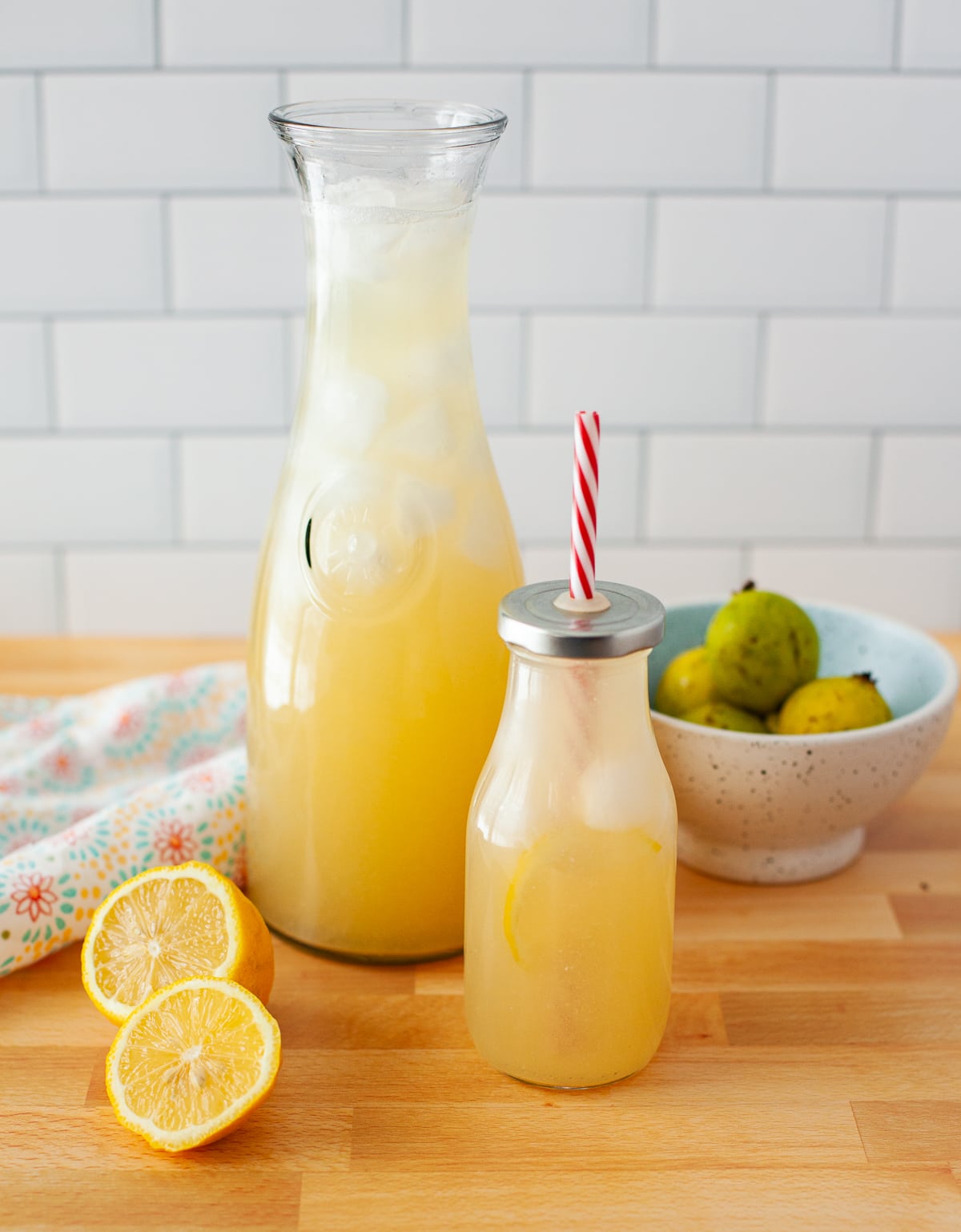 glass carafe and bottle filled with homemade lemonade made with fresh lemons.  