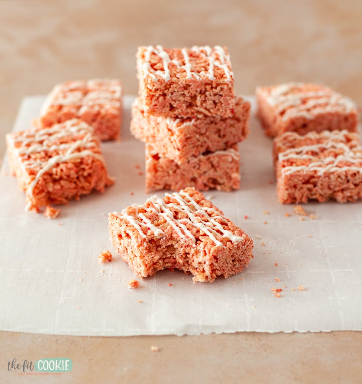 stacked squares of rice crispy treat bars with a bite taken. 
