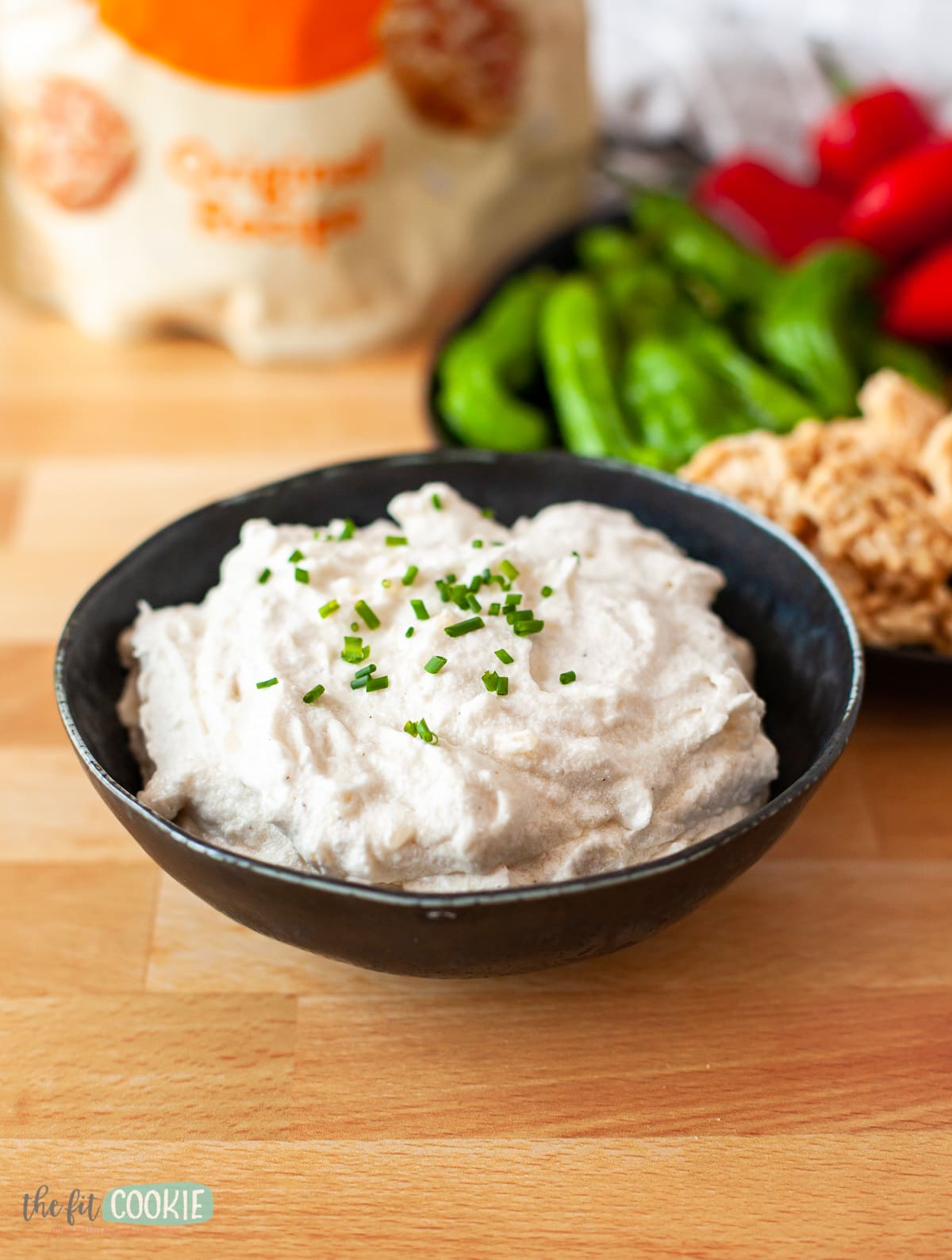 black bowl filled with dairy free french onion dip. 