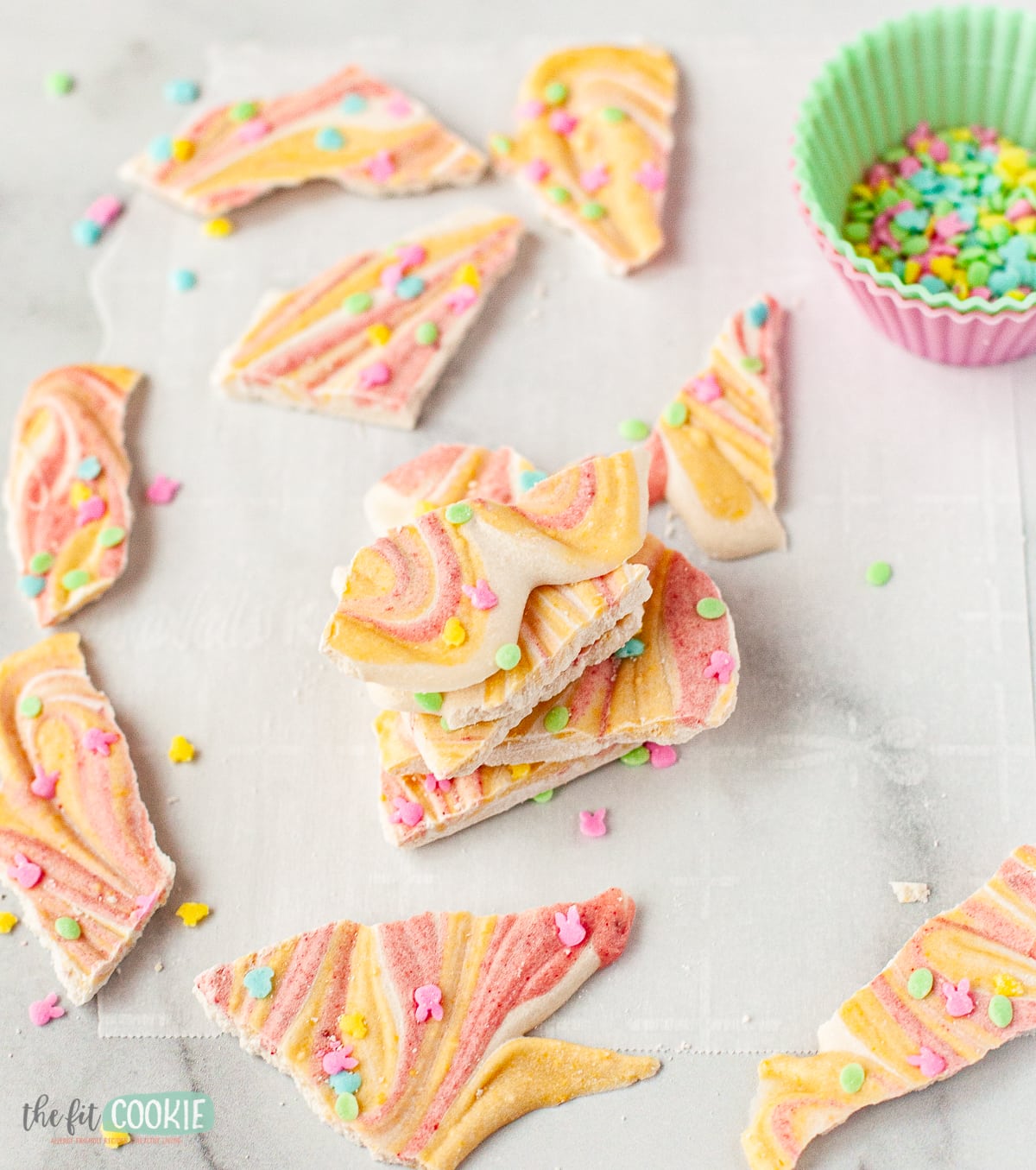 photo of pieces of stacked dairy free white chocolate bark with pastel color swirls.  