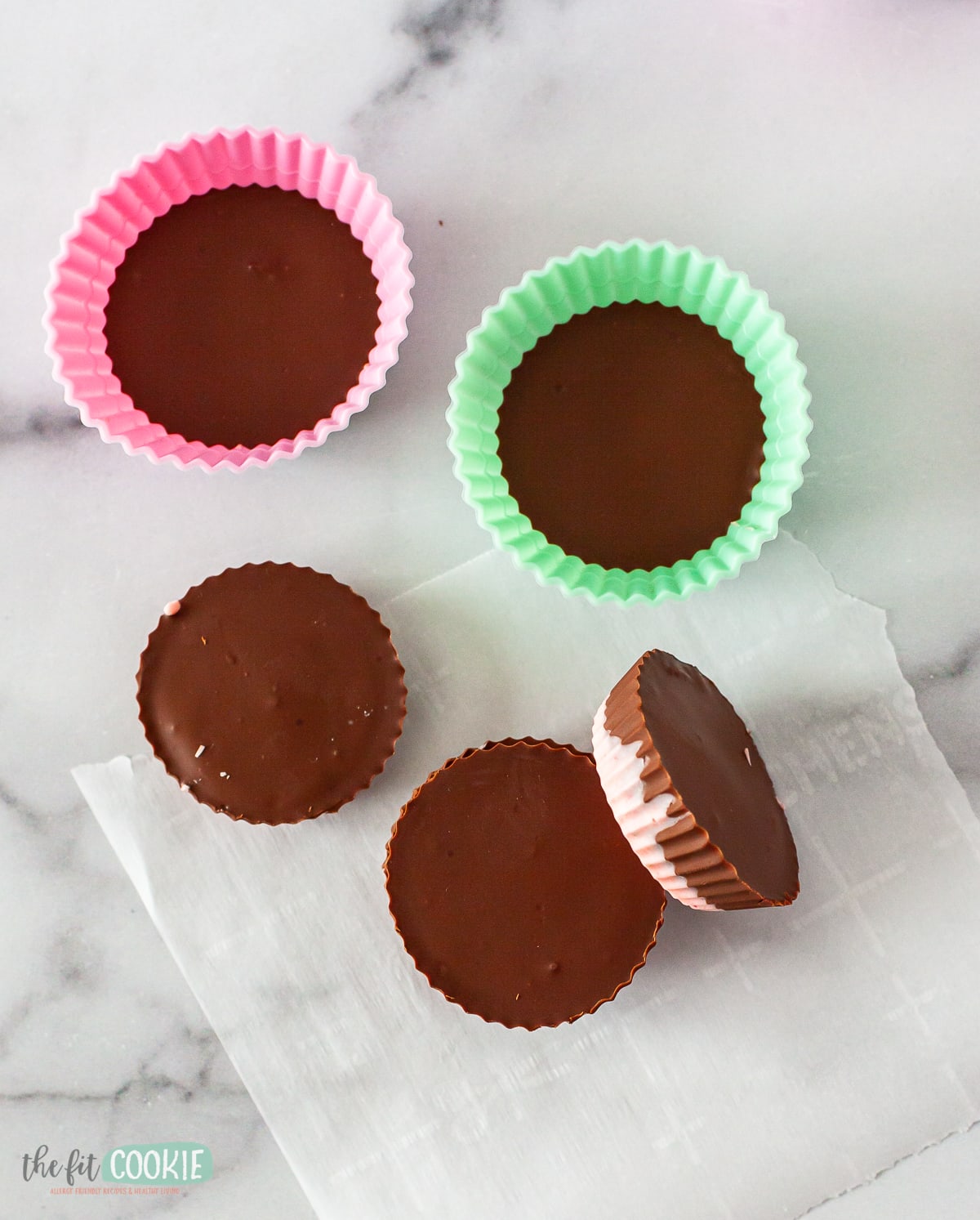 overhead photo of peanut free chocolate cups on a marble surface. 