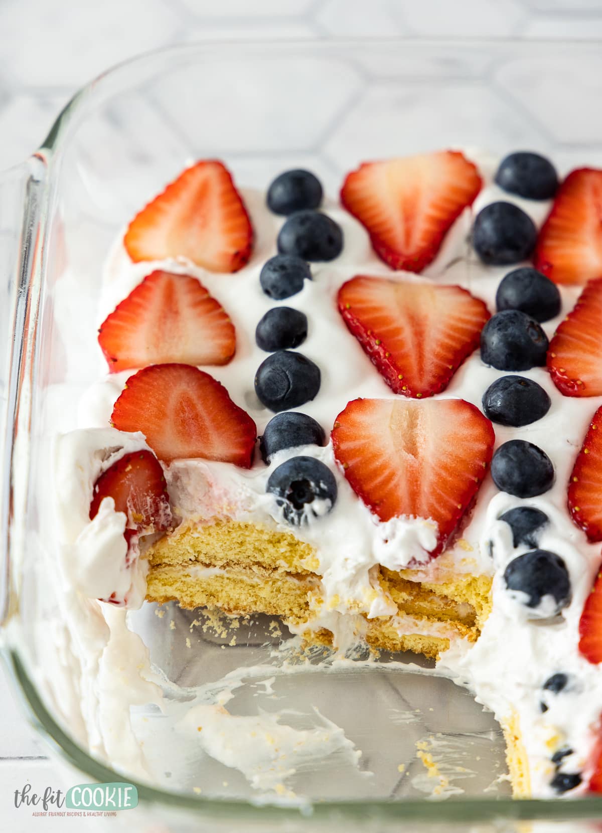 close up photo of gluten free icebox cake with fresh fruit in a glass pan. 