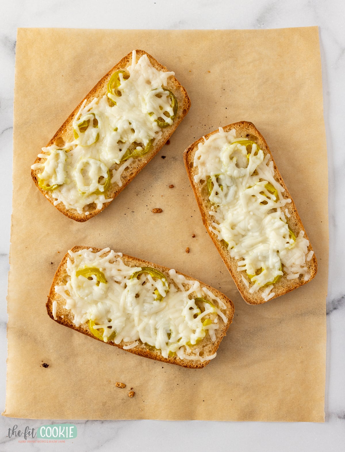 overhead photo of dairy free garlic cheese bread on brown parchment paper. 