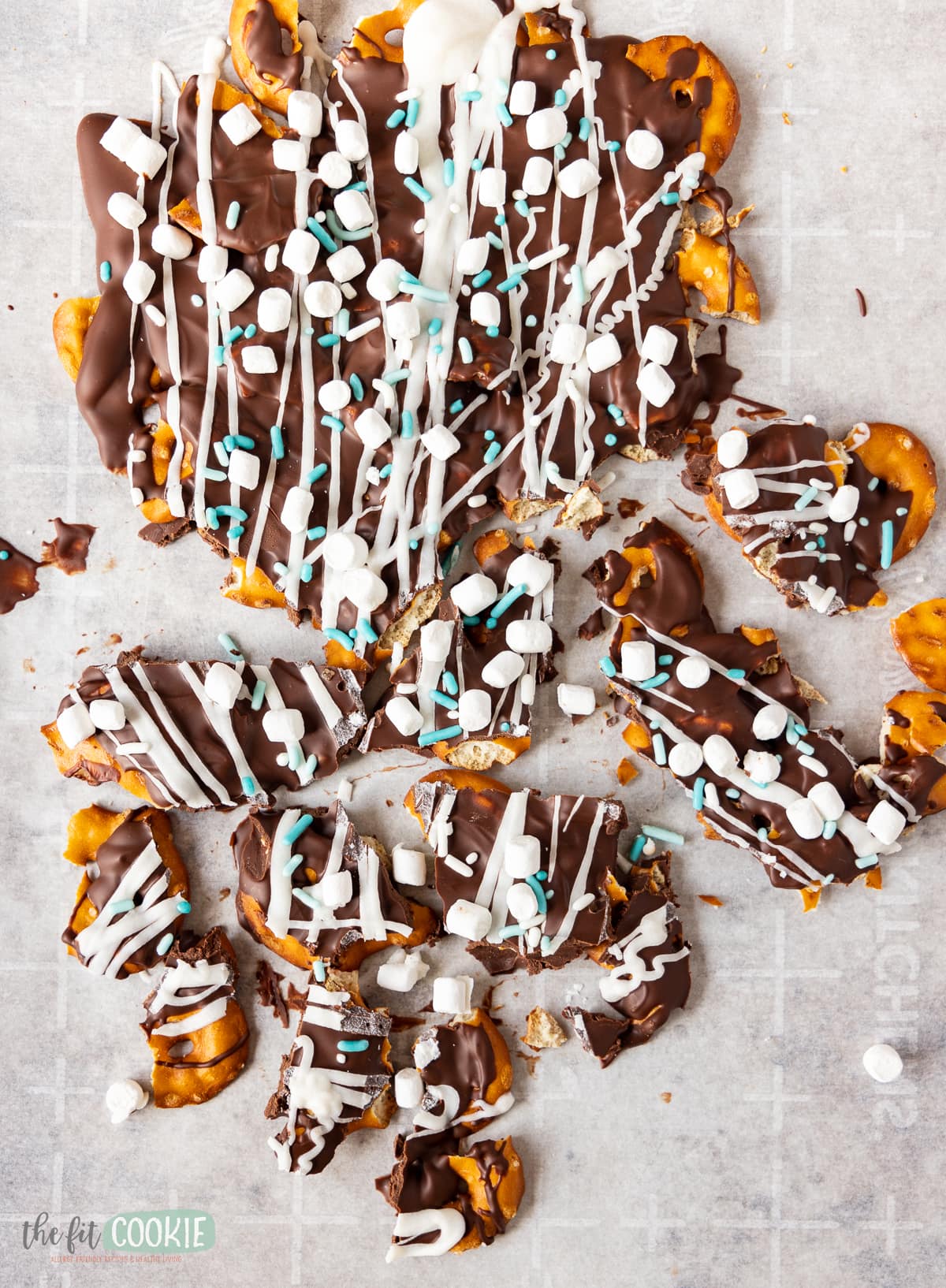 overhead photo of dairy free chocolate bark broken into pieces on parchment paper. 