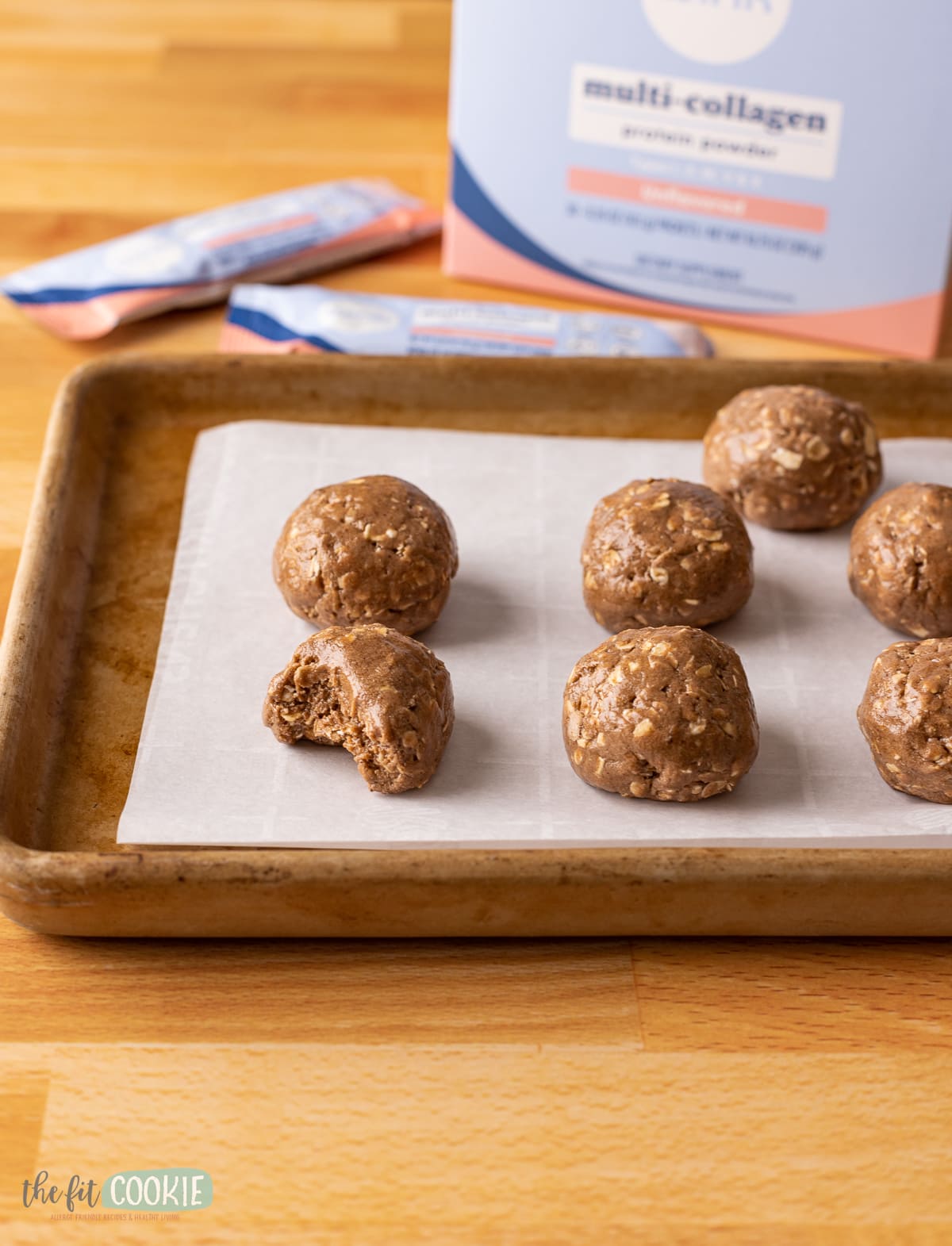 multiple protein bites on a stoneware pan lined with parchment paper. 