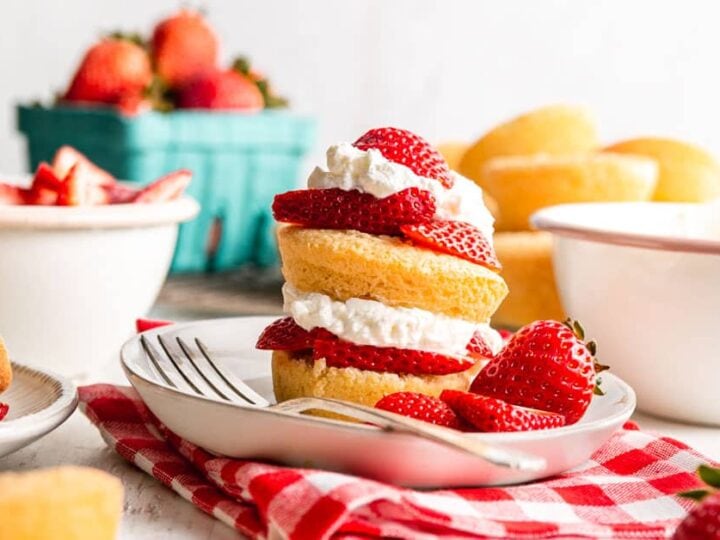 Strawberry shortcakes topped with whipped cream and strawberries.