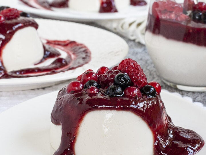 A dessert with berries and cream on a plate.