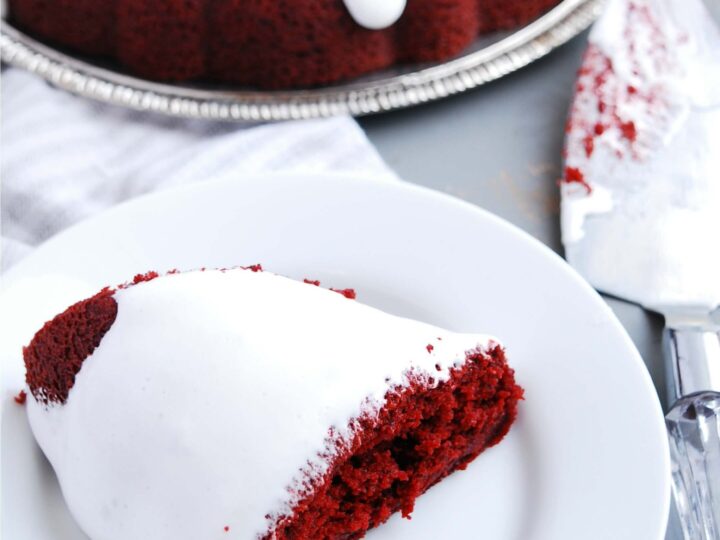 Red velvet bundt cake with white icing.