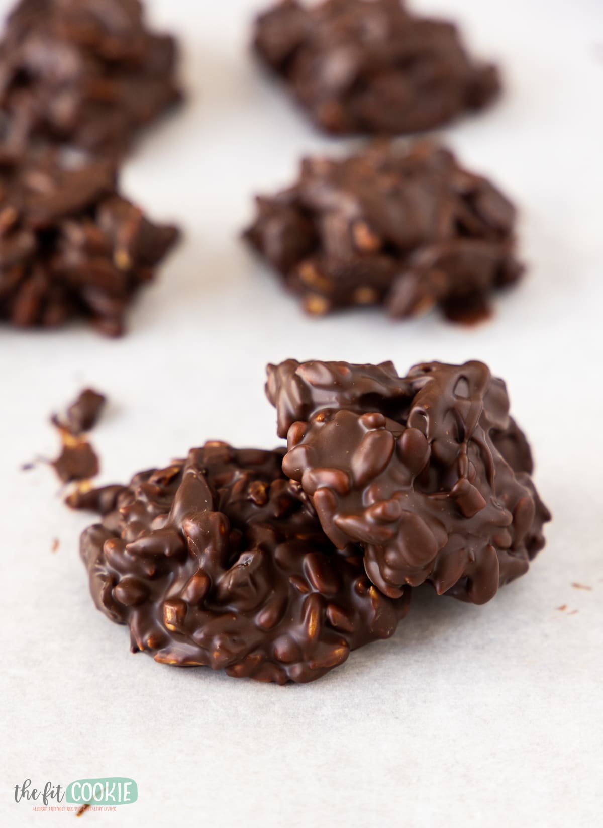 close up photo of chocolate clusters made with cherries and sunflower seeds. 