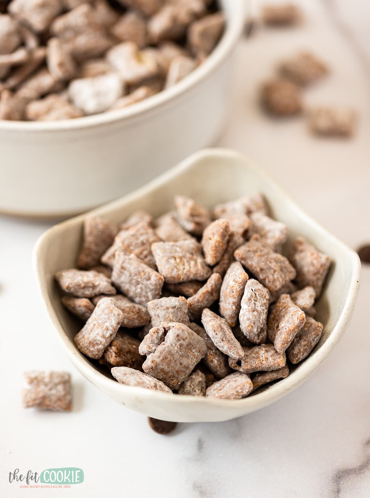 close up photo of muddy buddies in a white bowl. 