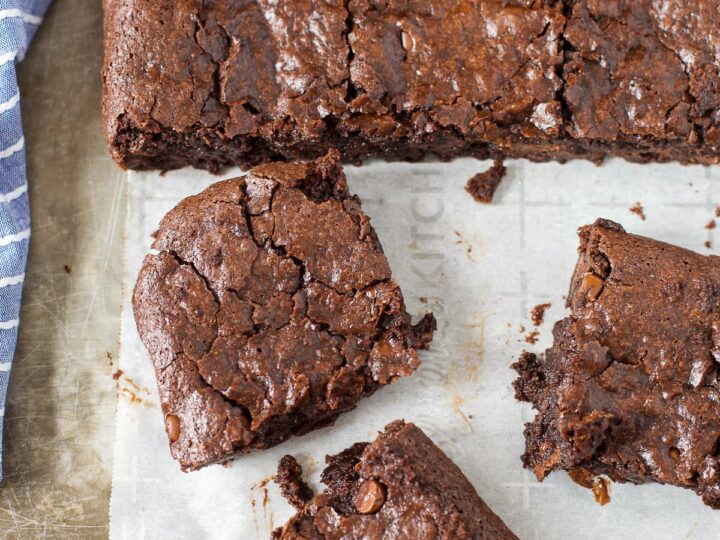 Chocolate fudge brownies on a baking sheet with a knife.