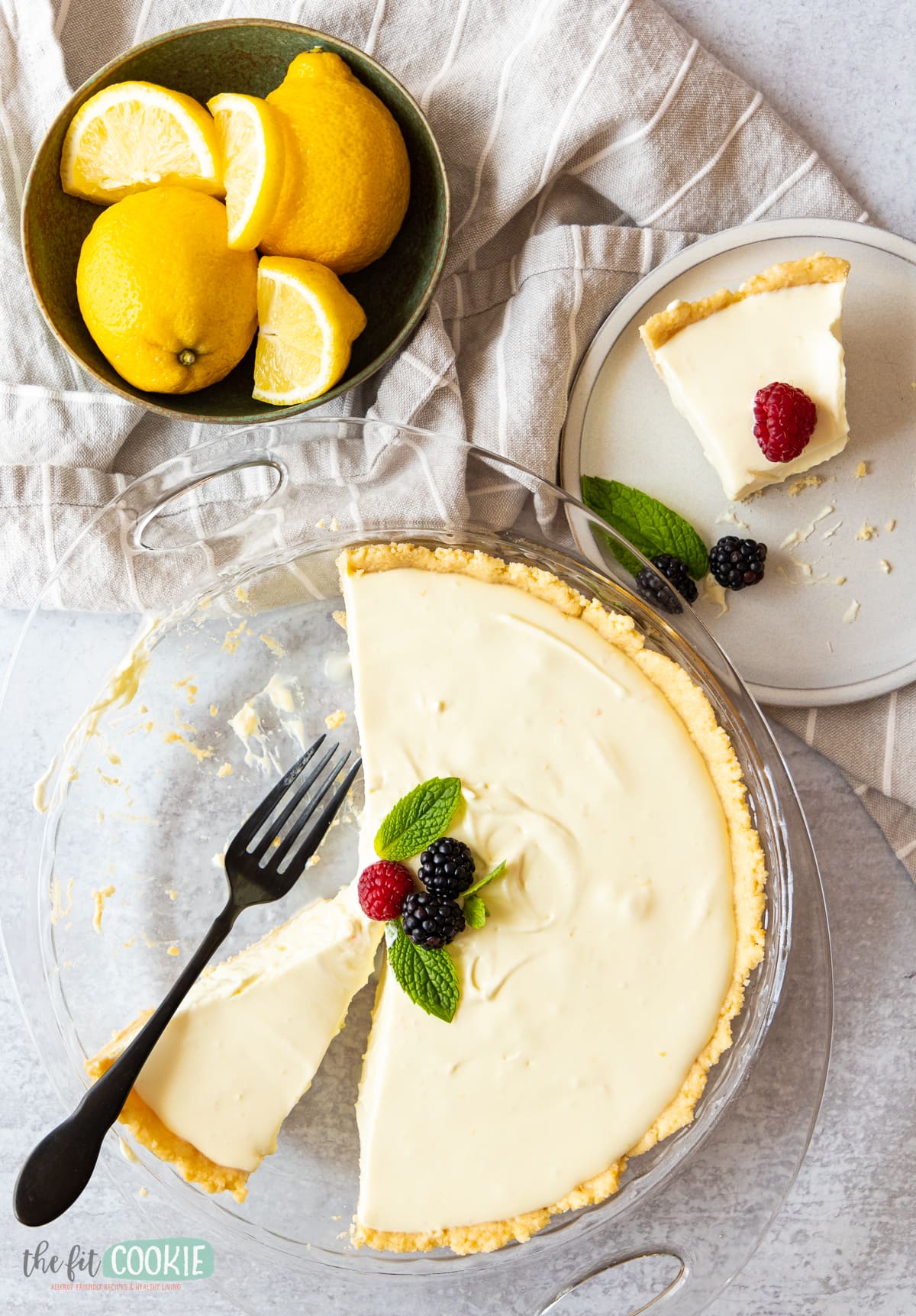 overhead photo of dairy free lemon cheesecake garnished with berries.