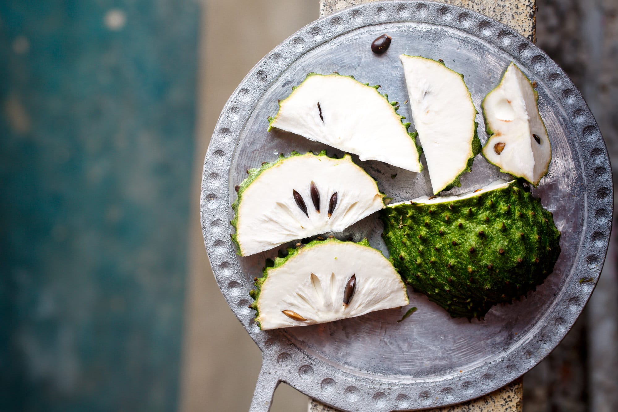 cut soursop/guanabana on a gray colored tray. 