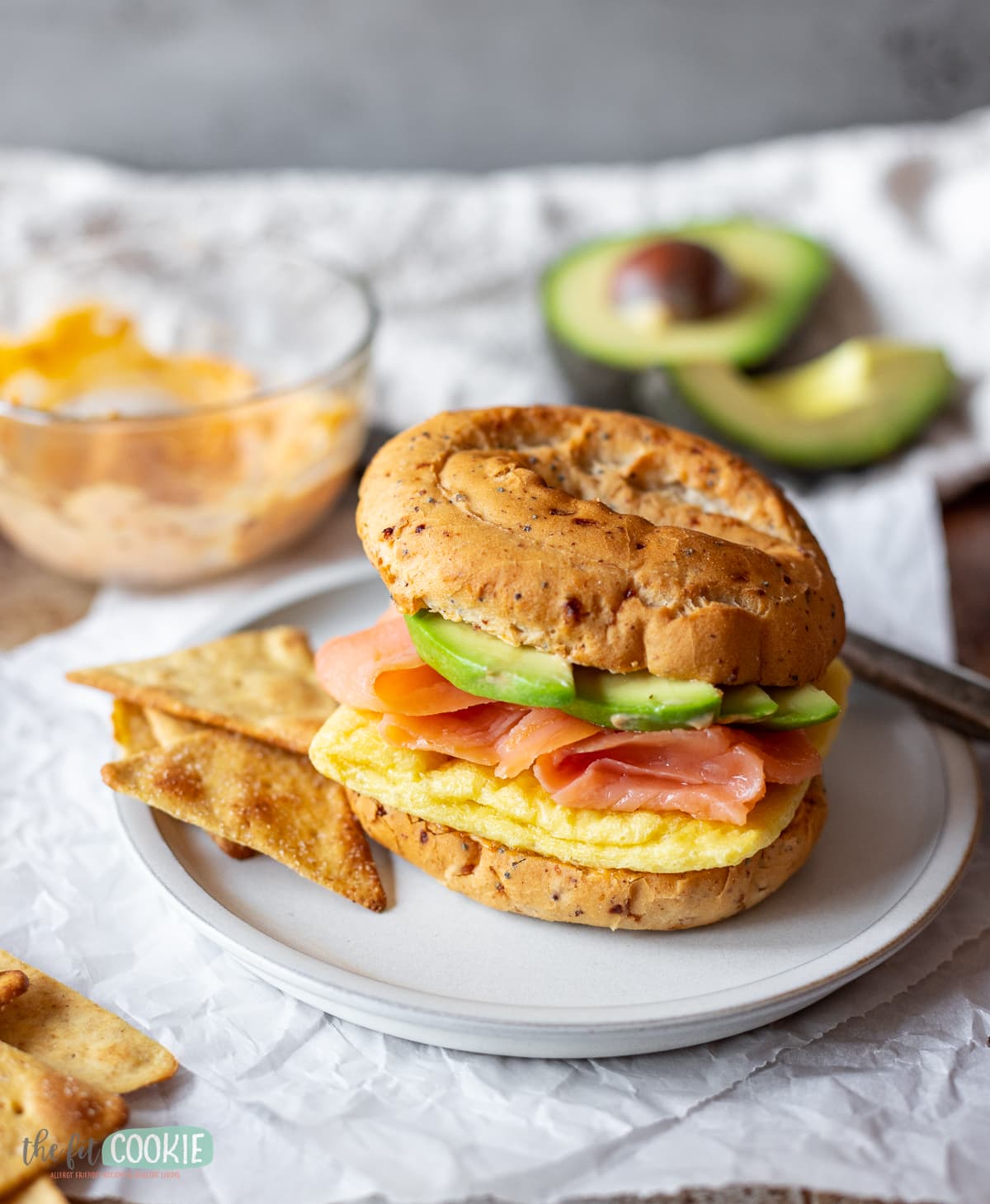 close up photo of bagel breakfast sandwich with smoked salmon and avocado. 
