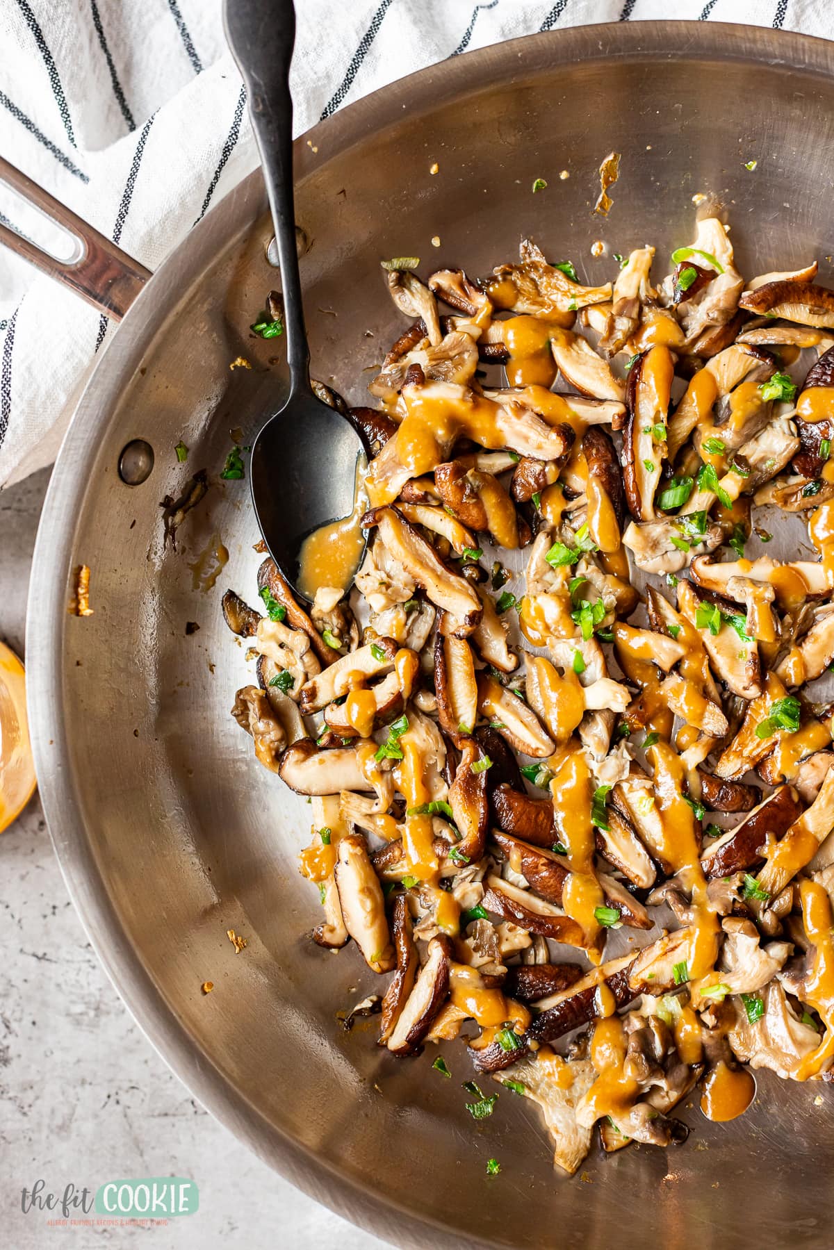 overhead photo of a skillet with sauteed oyster mushrooms and shiitake mushrooms with miso sauce. 