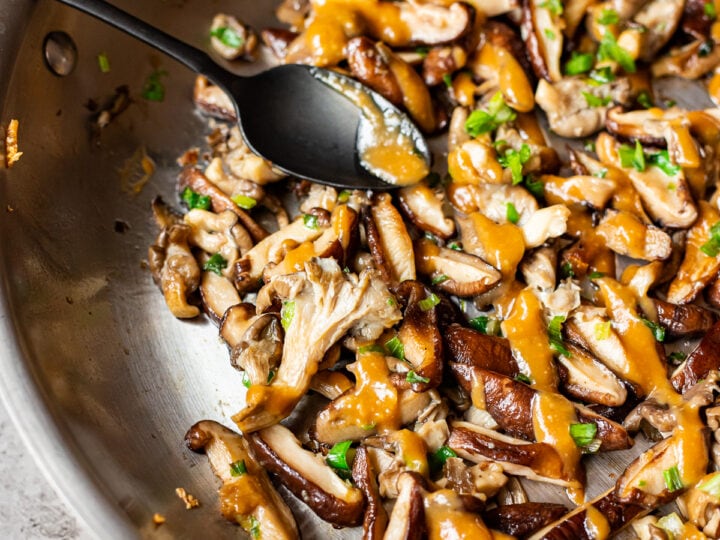 Shiitake mushrooms cooked in a wok with sauce.