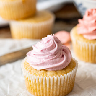Strawberry cupcakes with strawberry frosting and strawberries.