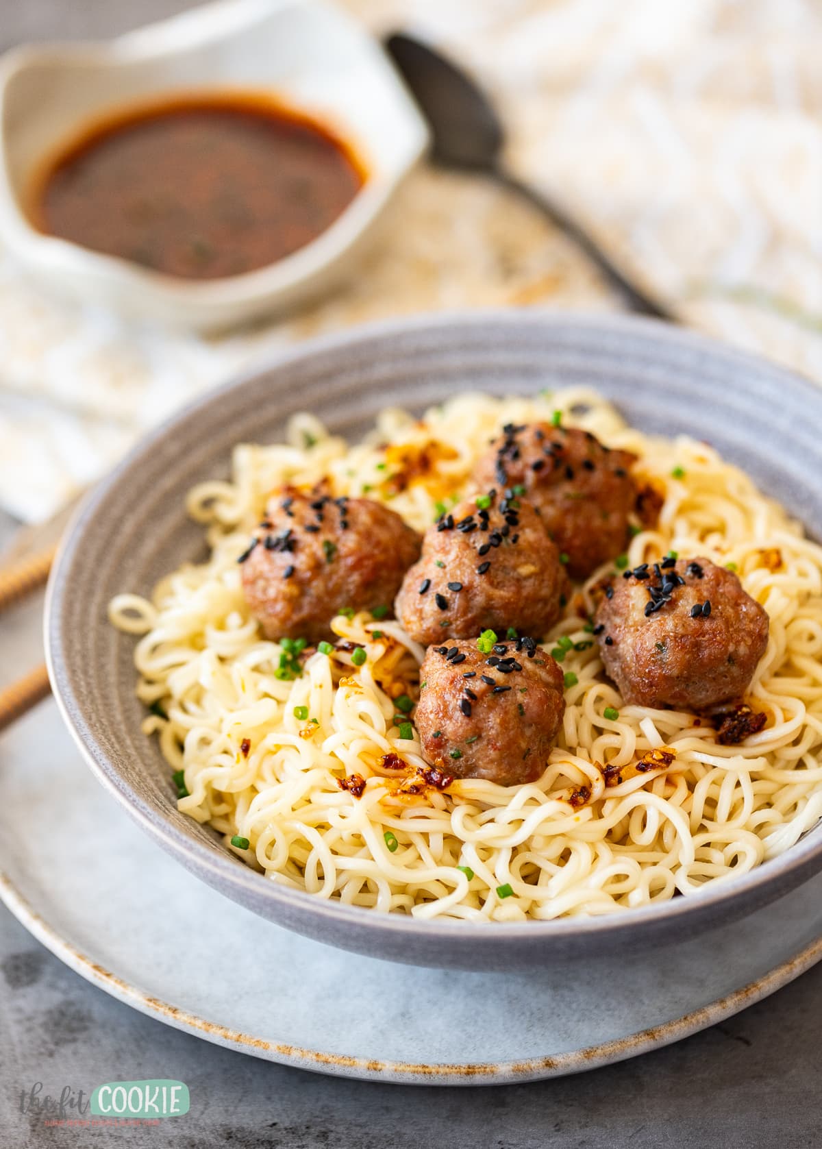 A bowl of pork meatballs with sauce.