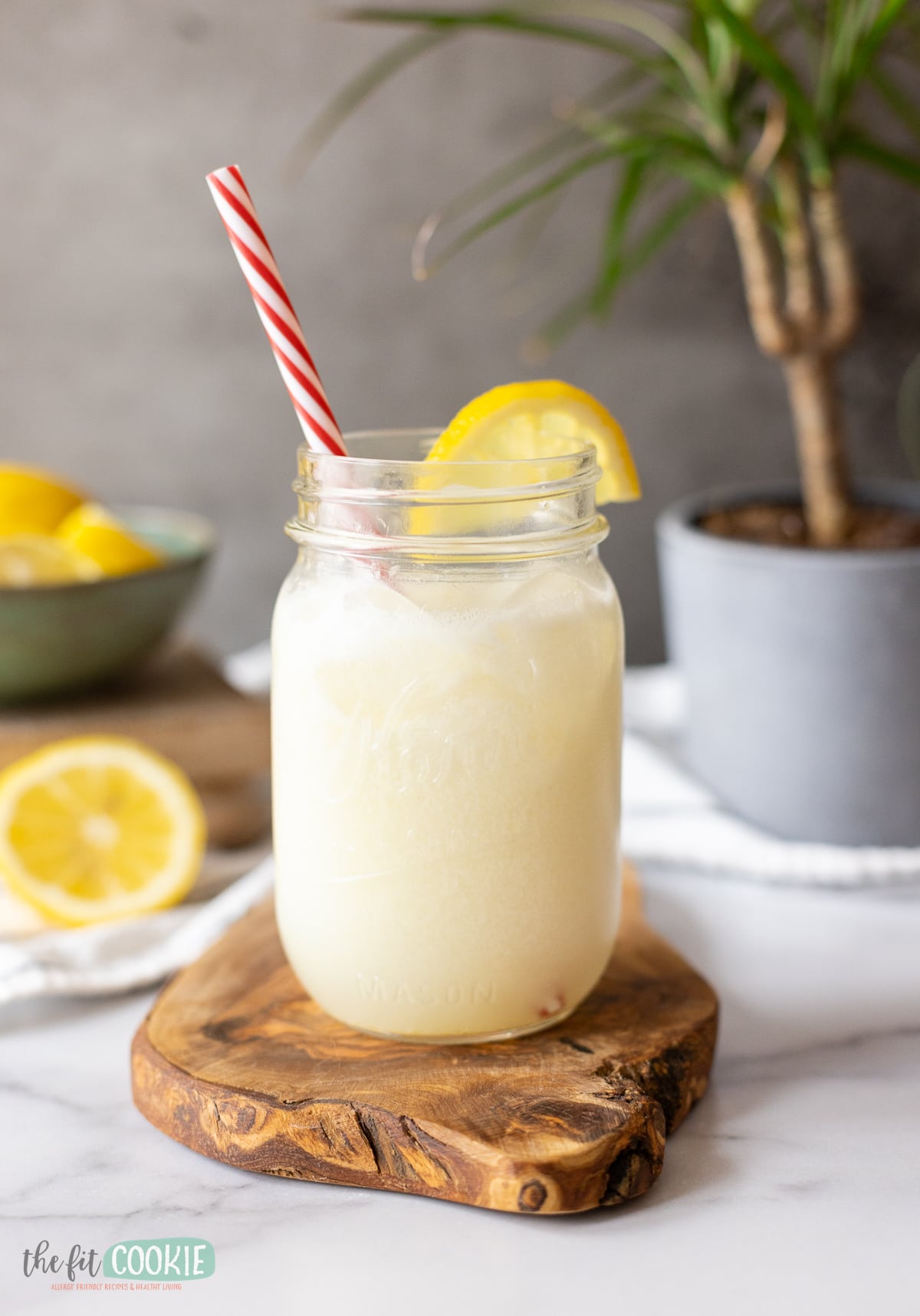 Brazilian lemonade served in a mason jar with a straw.