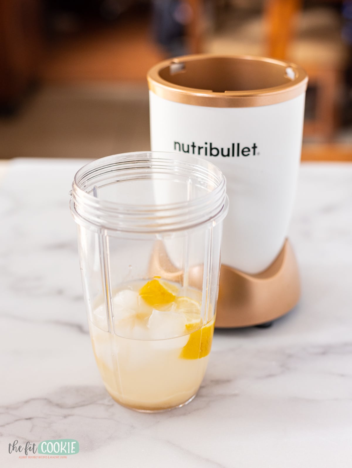 NutriBullet blender container filled with ingredients to make brazilian lemonade with lemons. 