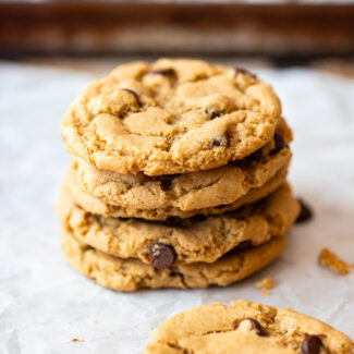 A stack of sunbutter chocolate chip cookies on a baking sheet.