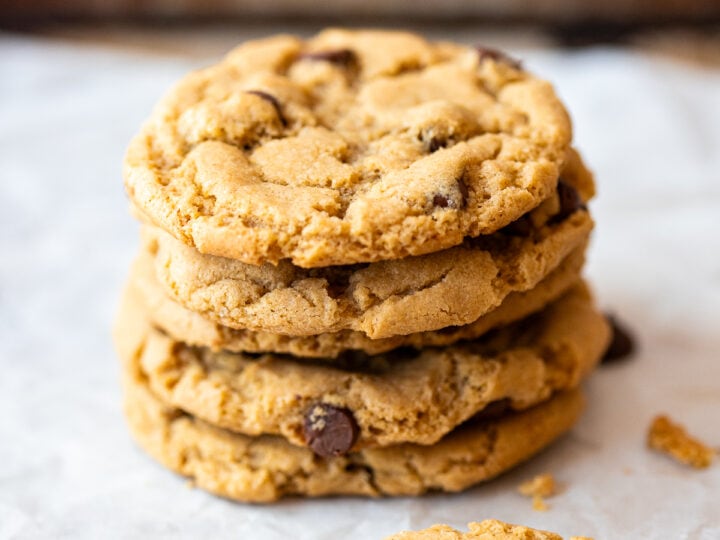 A stack of sunbutter chocolate chip cookies on a baking sheet.