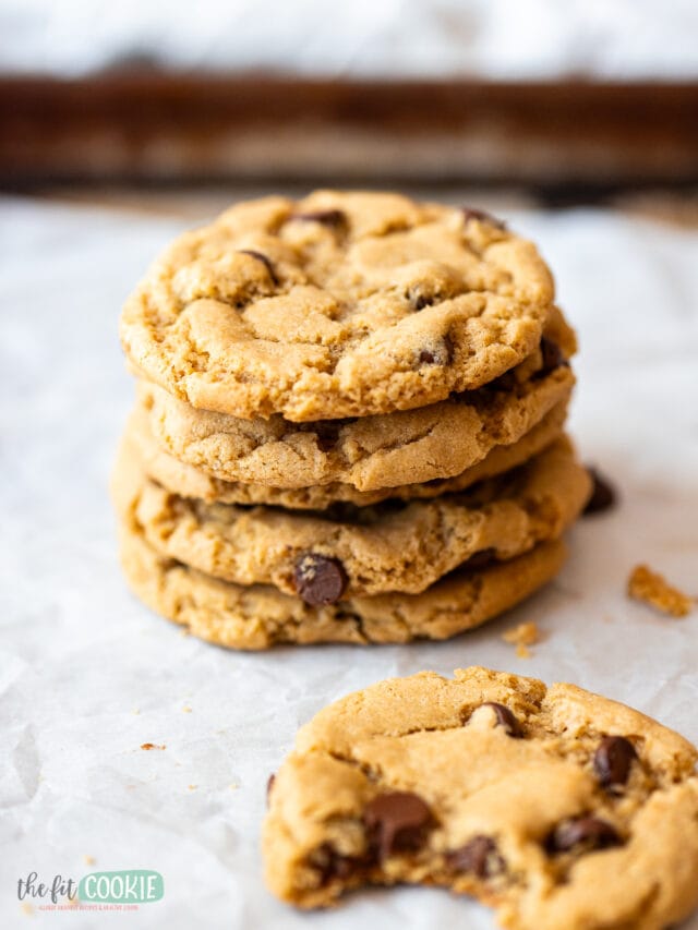 A stack of chocolate chip cookies on a baking sheet.