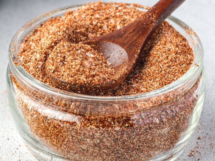 A bowl of seasoning with a wooden spoon.