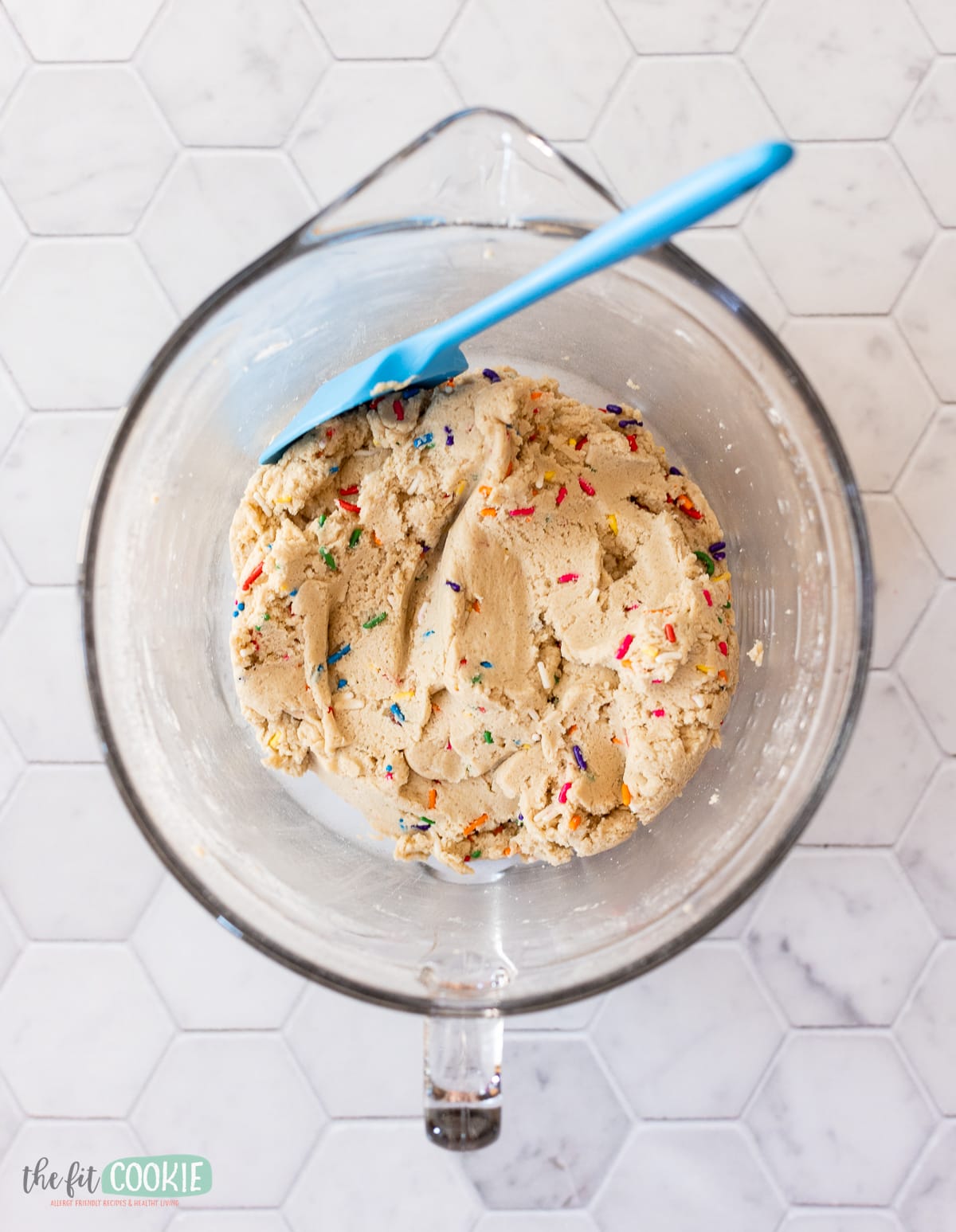 overhead photo of glass batter bowl with confetti cookie dough inside. 