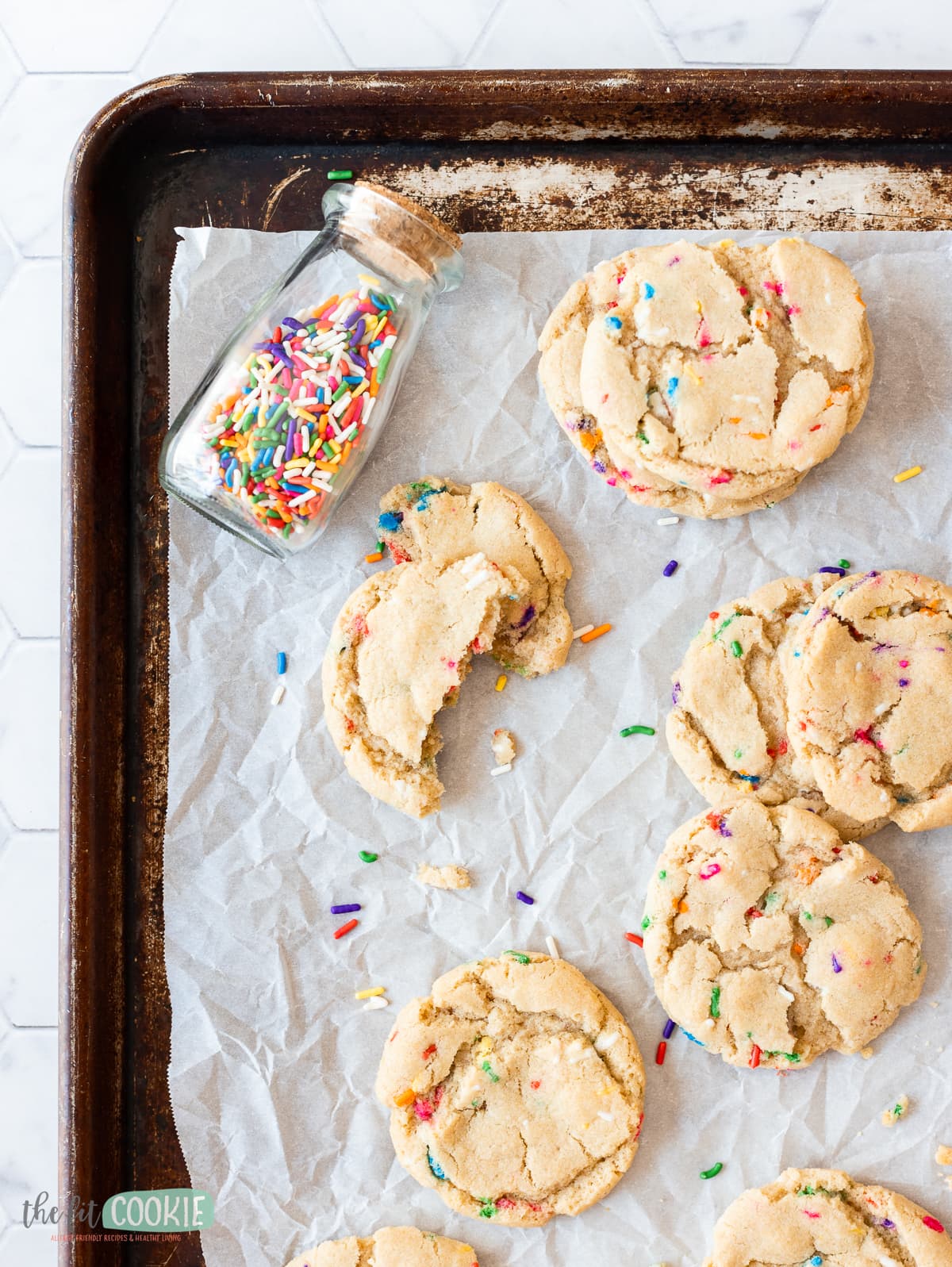 overhead photo of gluten free sprinkle cookies on a baking sheet.