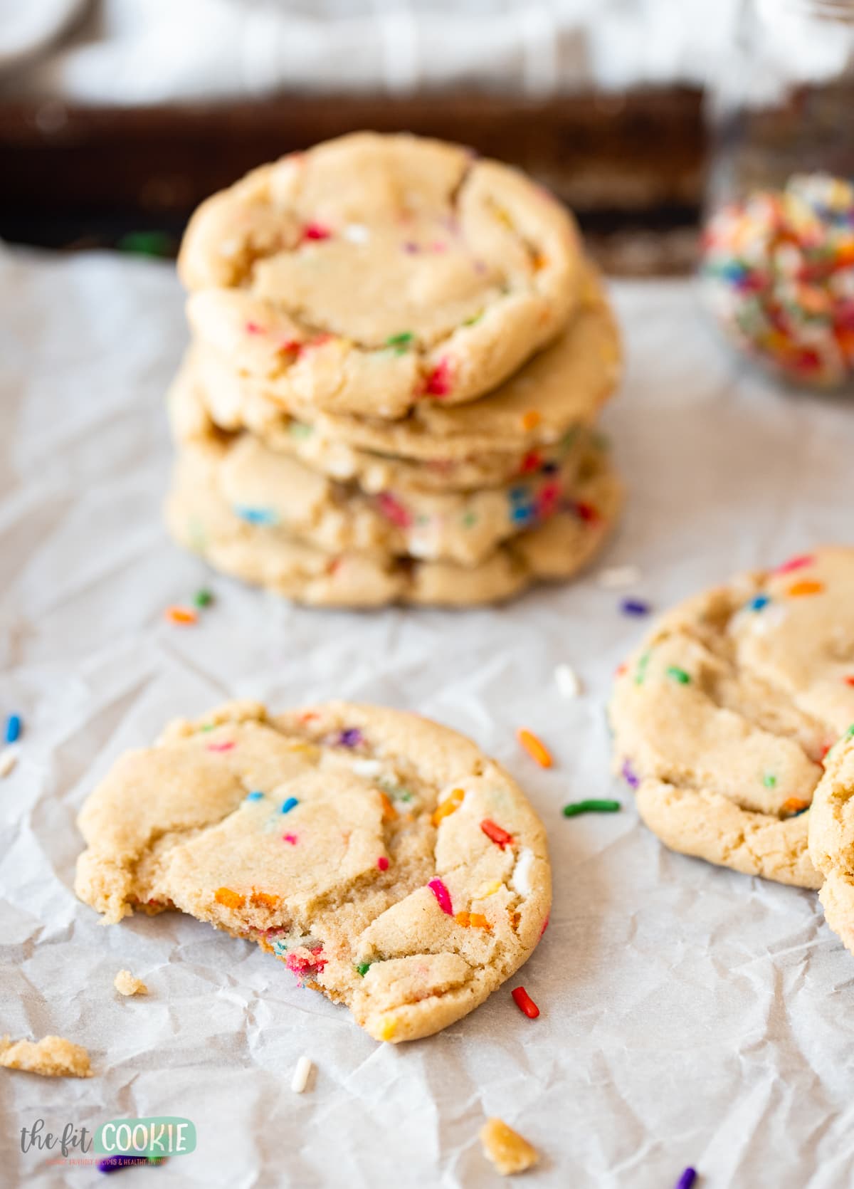 close up photo of gluten free sprinkle cookies on parchment paper. 