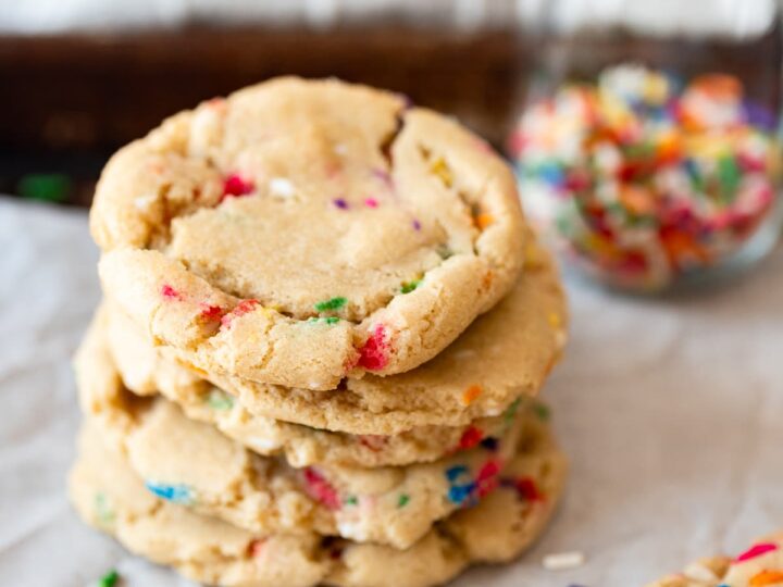 Funfetti cookies stacked with sprinkles.