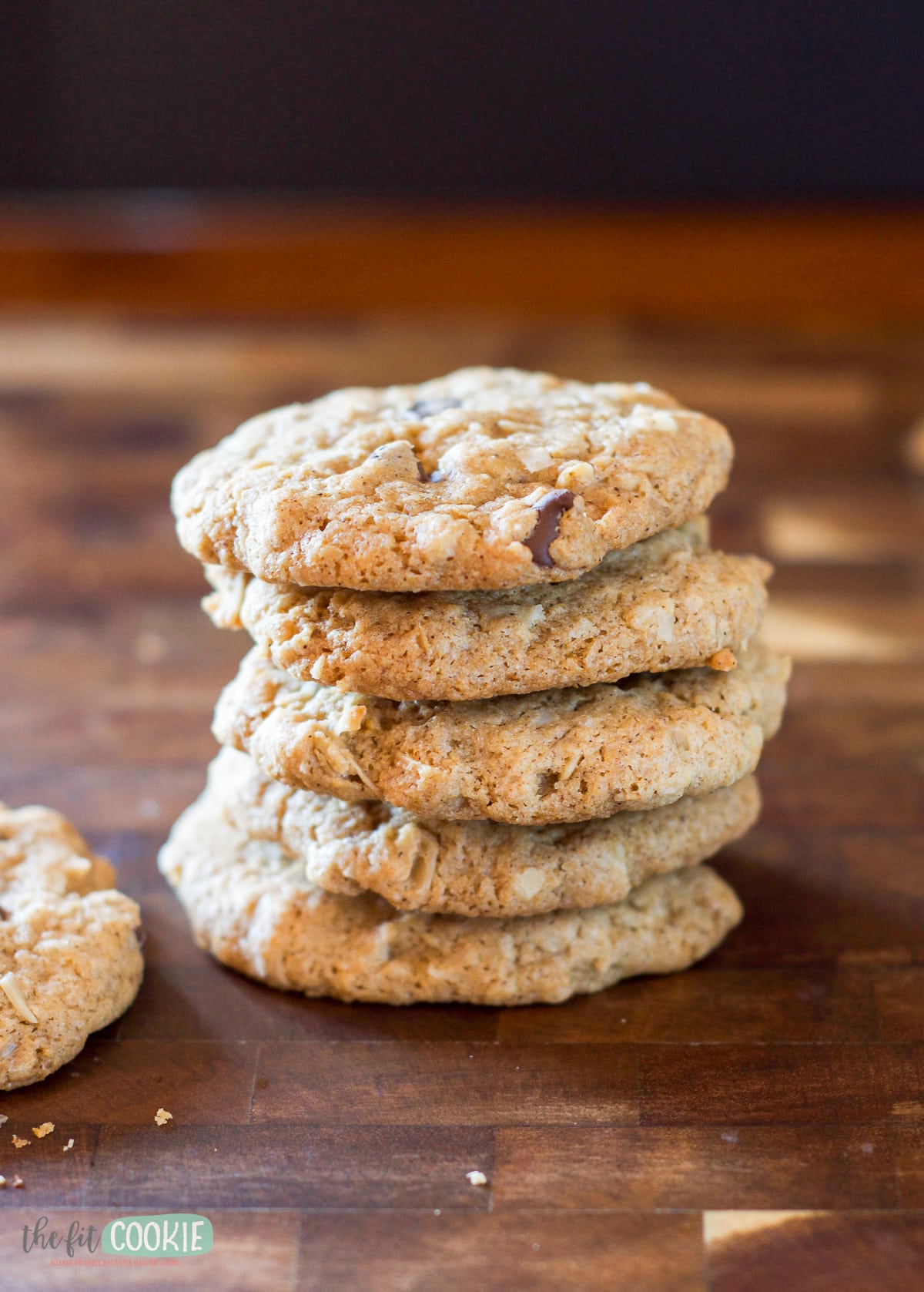 A stack of oatmeal cowboy cookies on a wooden board.