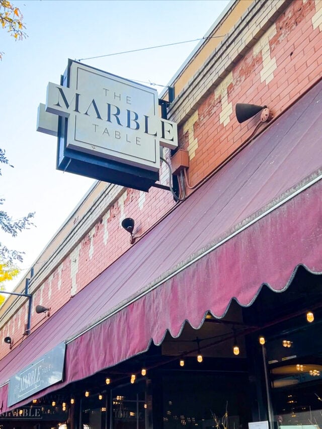 A restaurant with a sign that says the marble house.