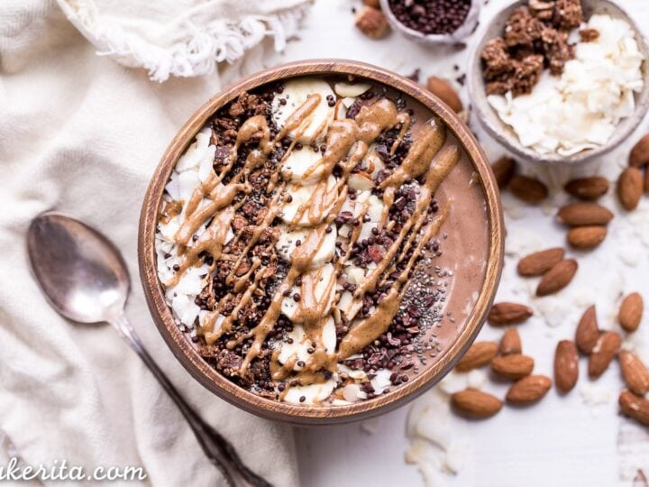 A bowl filled with chocolate and almonds.