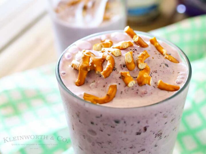 A purple smoothie with pretzels on top.