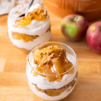 gluten free and vegan Caramel apple cheesecake cups on a wooden table.